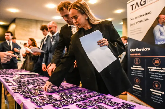 Guests picking up their badges at the welcome desk.