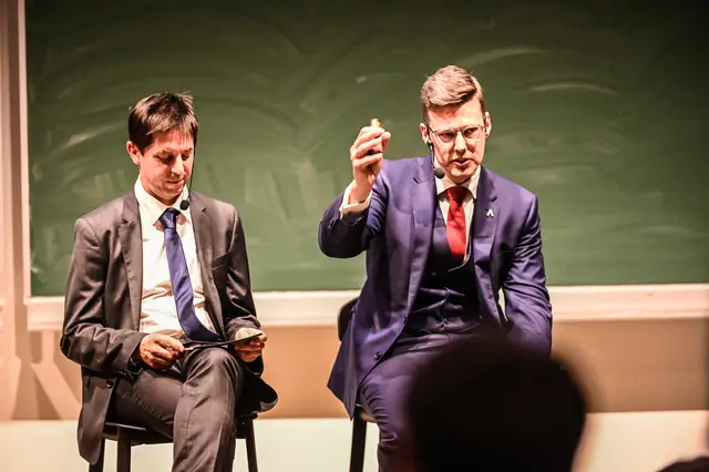 Two speakers on stage.