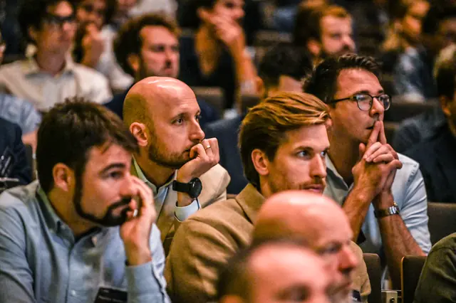 The audience listening closely.