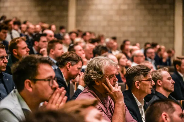 The audience following the demo.