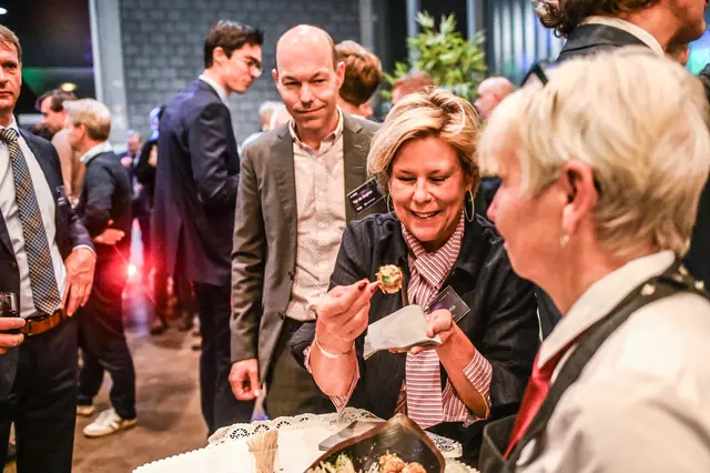 Guests laughing at a high table during the break.