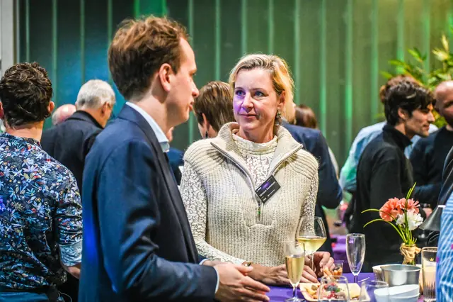 Guests talking at a high table during the break.