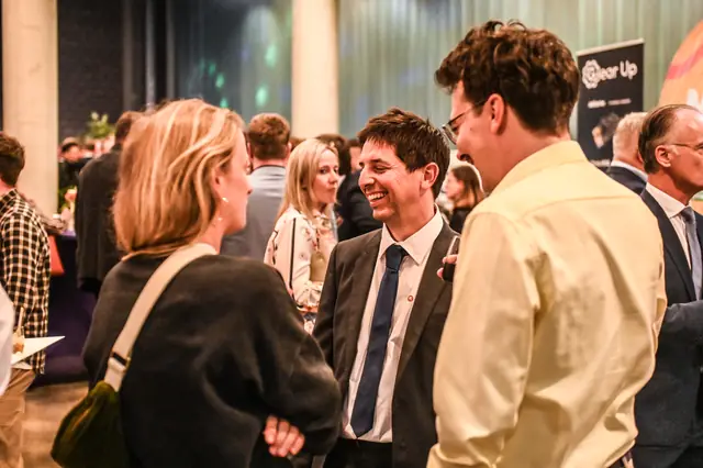 Guests in conversation during the break.