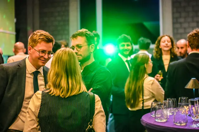 Guests under green light in the foyer.