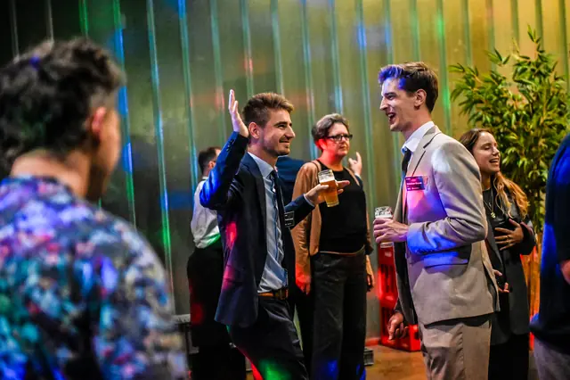 Guests dancing under the coloured lights.